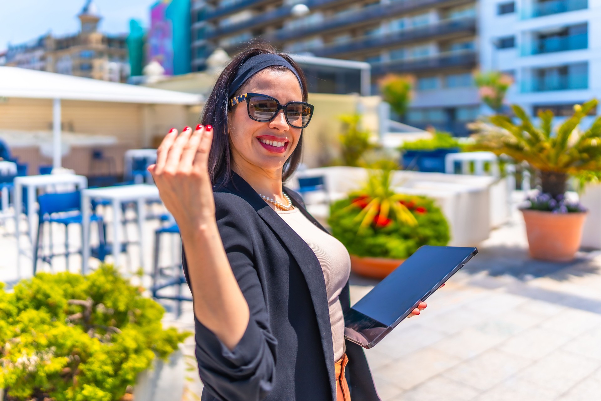 Businesswoman inviting to follow her on a luxury terrace